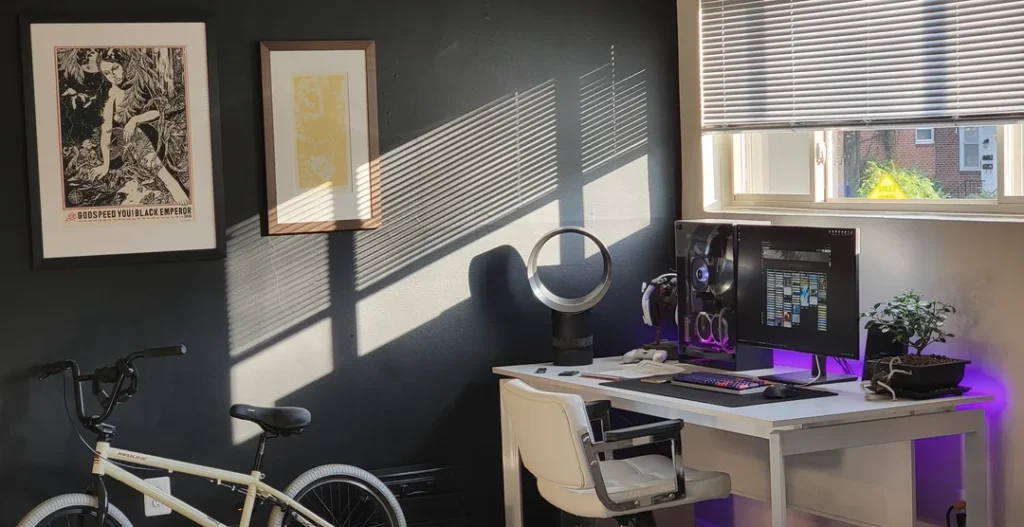 gaming desk setup right beside the window