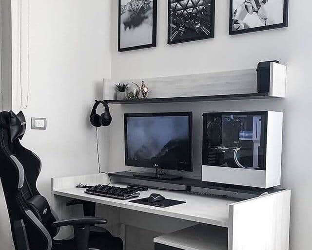 gaming station with desk and wall shelving