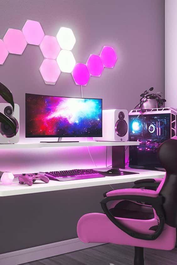 pink gaming desk setup with wall lighting
