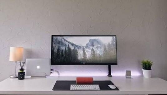 simple white gaming setup with a black monitor